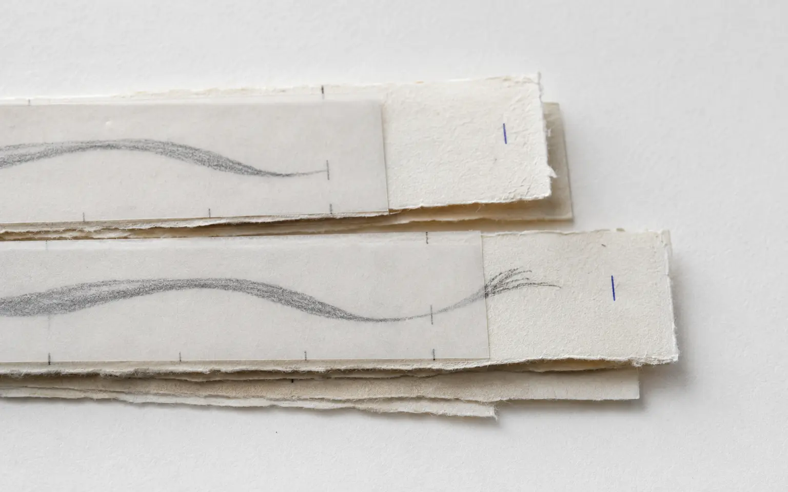 Paper token strips being compared on a quiet research surface